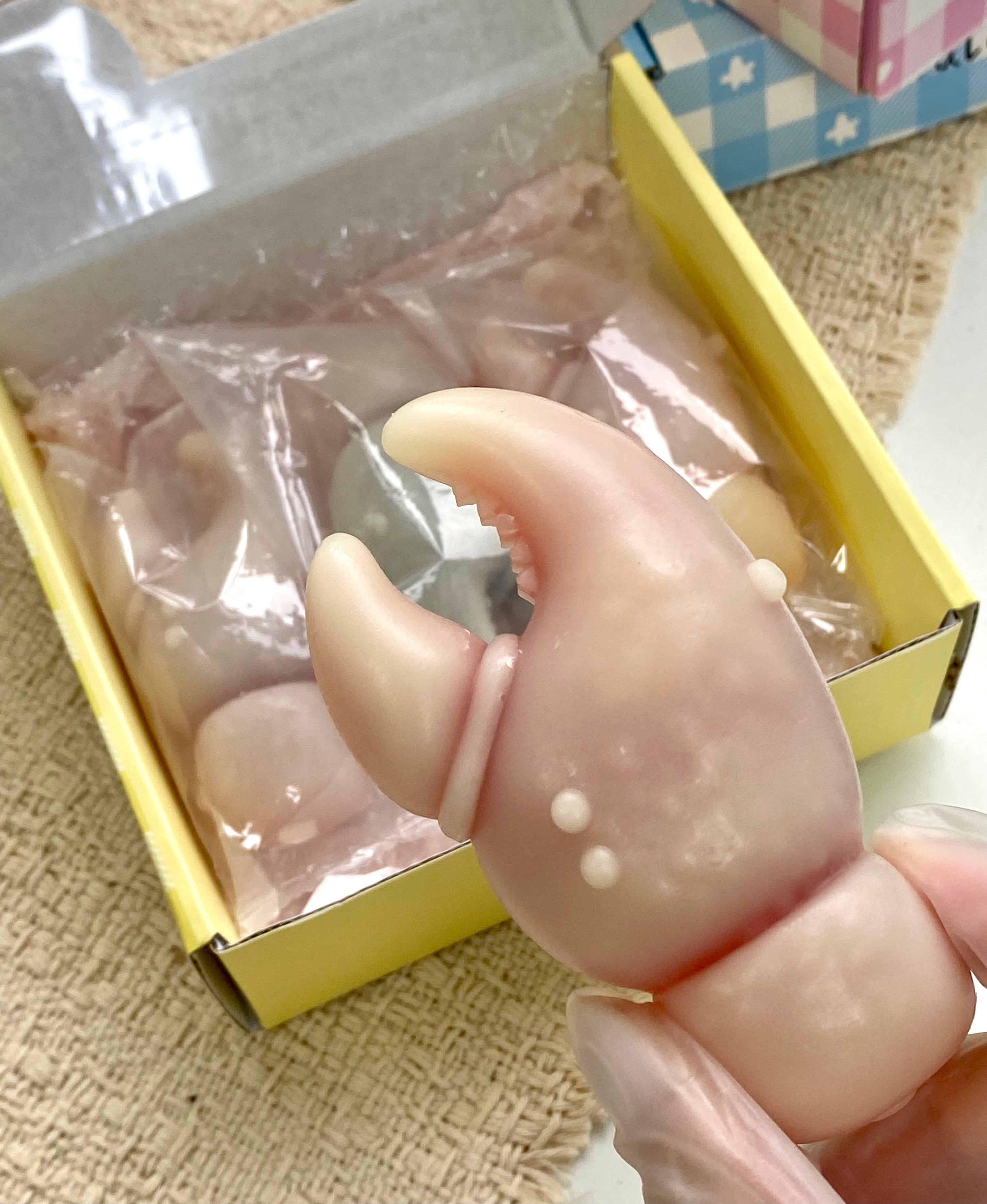 Close up of handmade crab claw wax bottle candy showing fruit juice filling inside