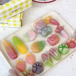 Close up of individually wrapped wax bottle candy pieces in various fun shapes from Oodles bulk box